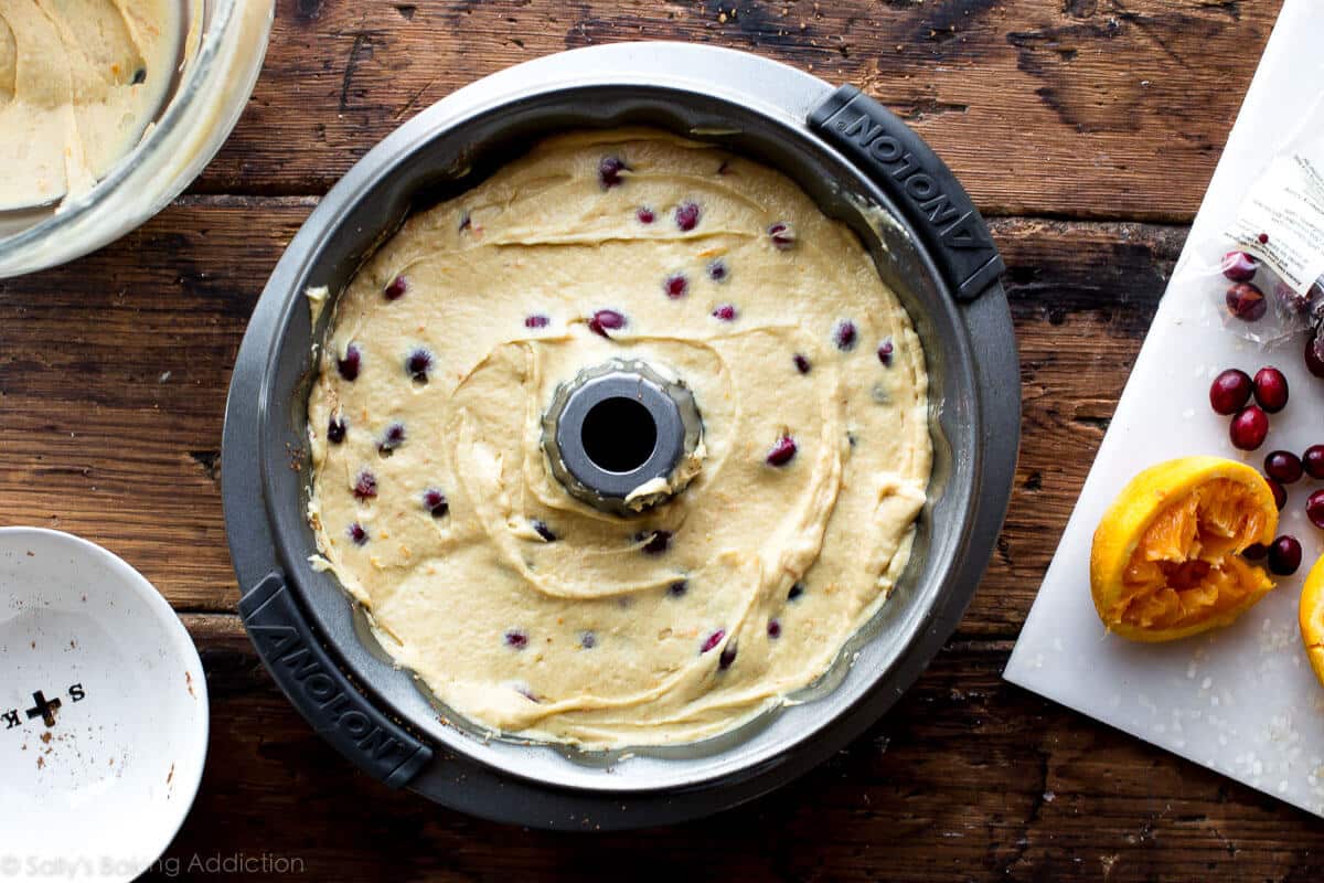 overhead image of remaining cake batter spread on top of cinnamon layer in a bundt pan
