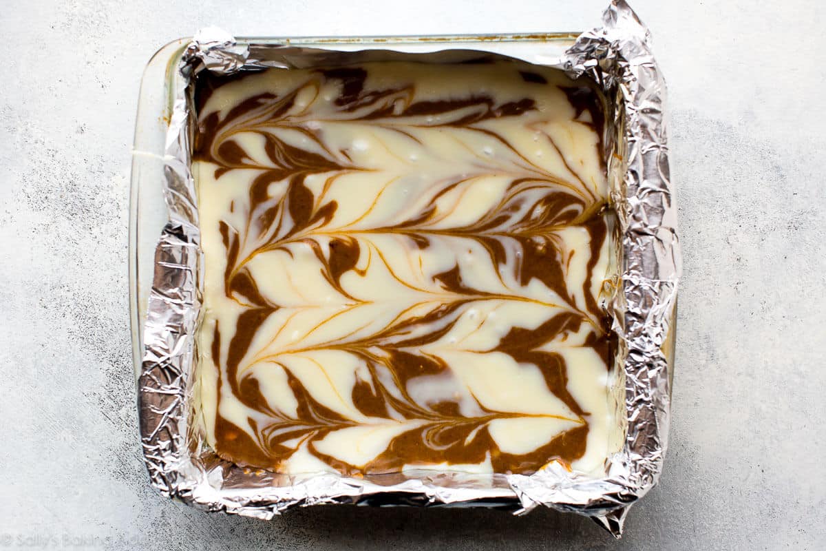 white chocolate and gingerbread fudge mixtures swirled in a square baking pan