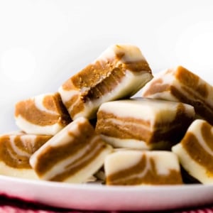 squares of gingerbread fudge stacked onto a white plate