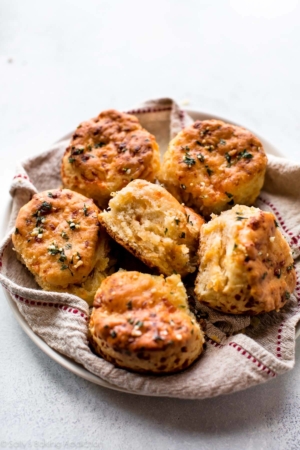 cheddar biscuits in a napkin lined bowl