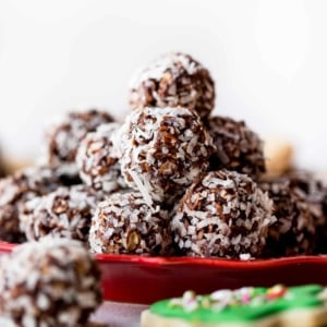 stack of no-bake chocolate coconut snowballs on a red plate