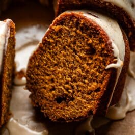 slice of pumpkin Bundt cake with maple icing on top.