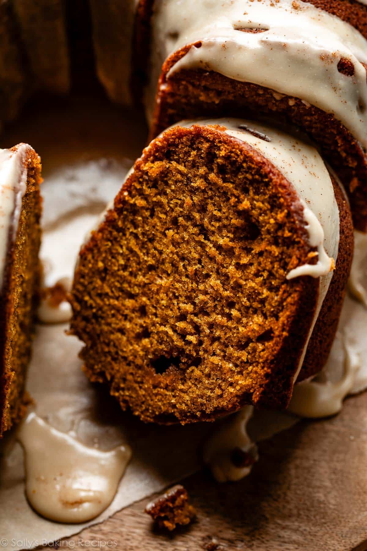 slice of pumpkin Bundt cake with maple icing on top.