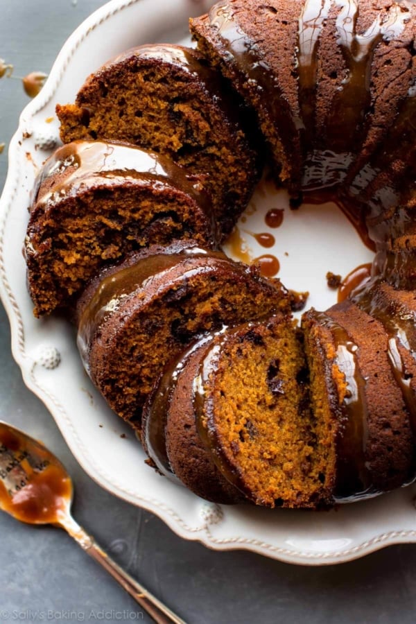 overhead image of pumpkin bundt cake cut into slices on a white serving plate