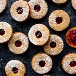 overhead image of raspberry pistachio linzer cookies