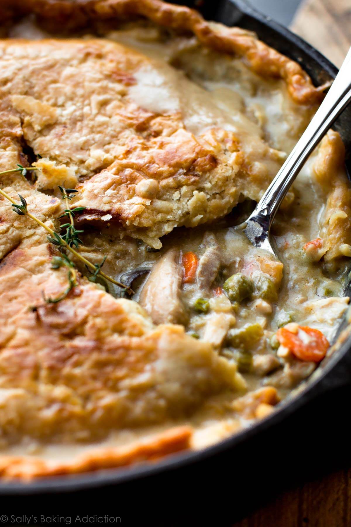 skillet pot pie with a serving spoon