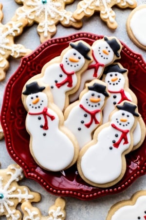 snowman sugar cookies on a red plate