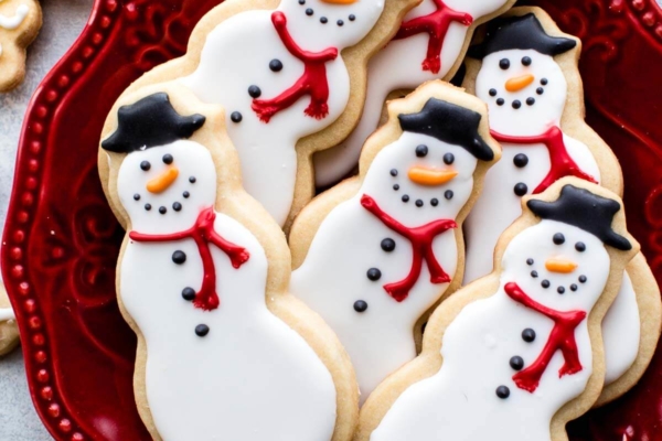 snowman sugar cookies on a red plate