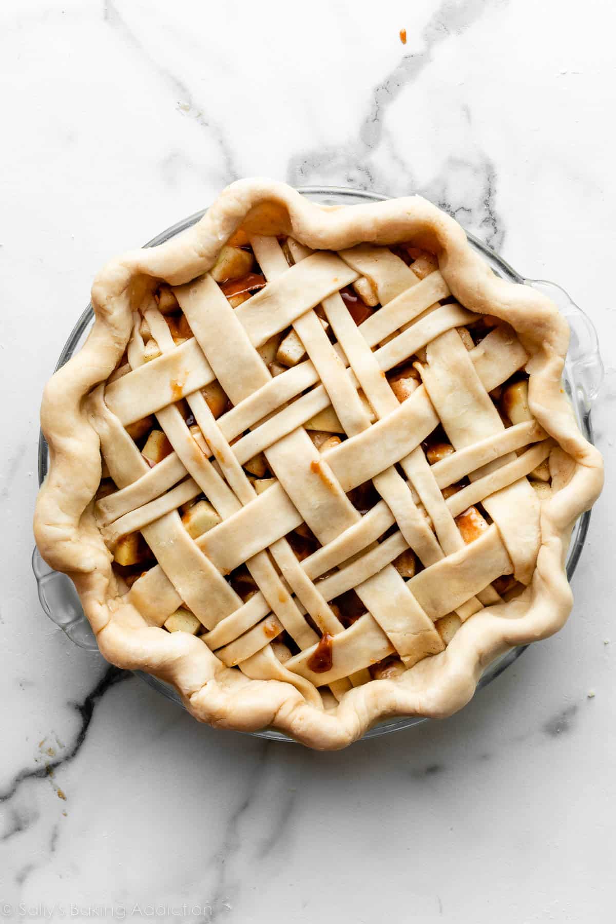 unbaked pie with fluted edge and thick and thin lattice design.