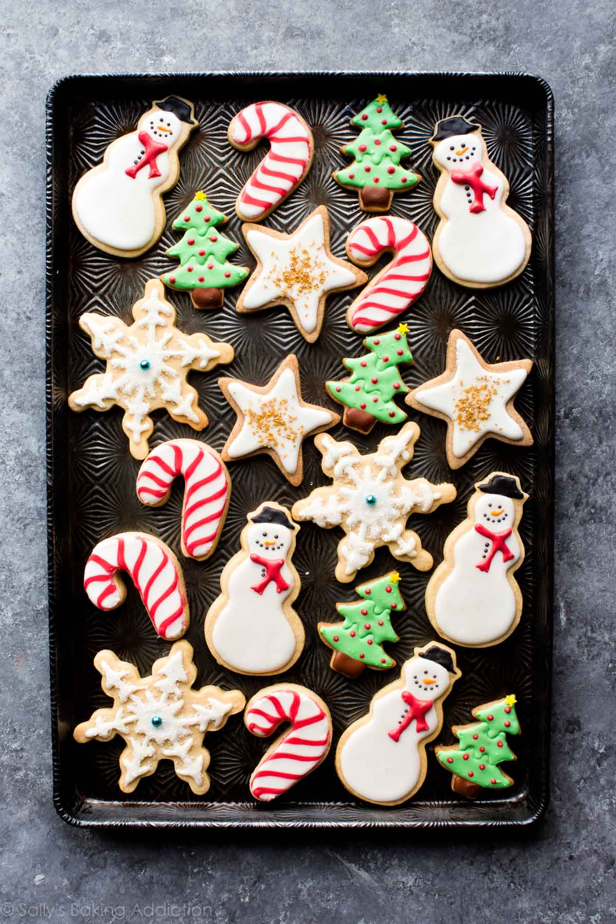 Christmas holiday decorated sugar cookies including snowmen, candy canes, Christmas trees, snowflakes, and stars