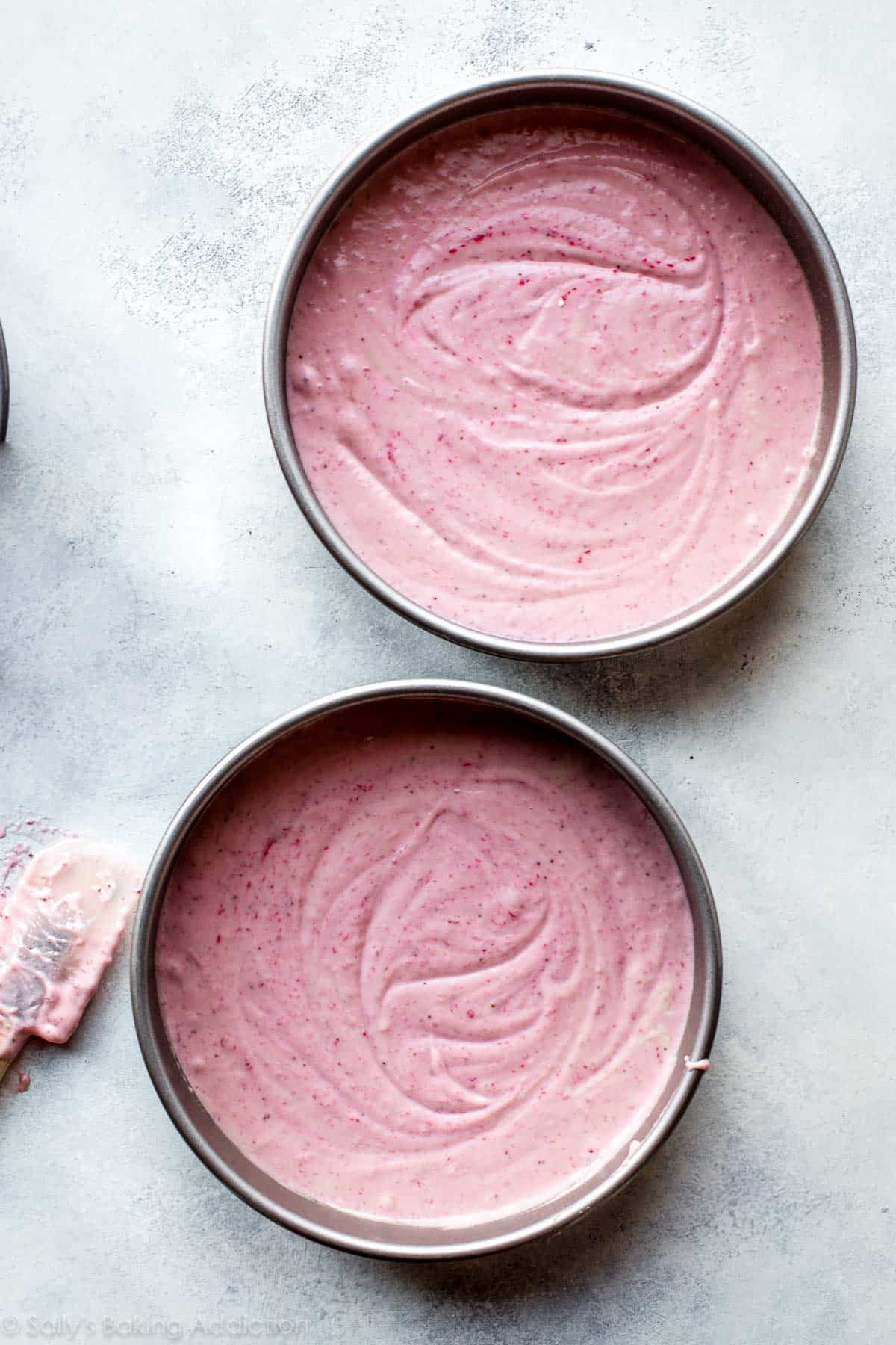 strawberry cake batter in round cake pans