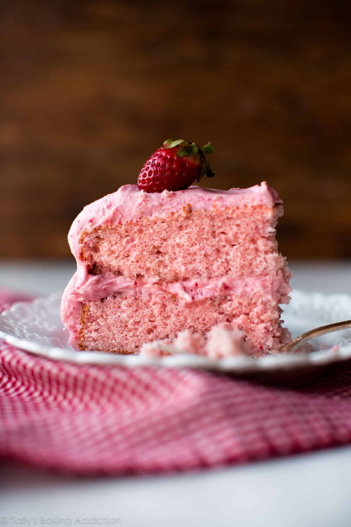 slice of homemade strawberry cake on a white plate