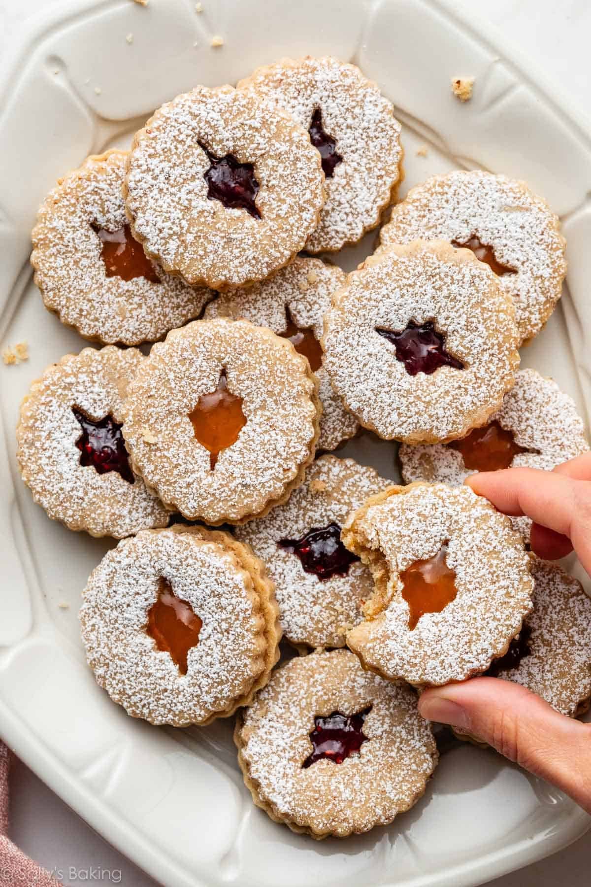 linzer cookies with raspberry and apricot jam on platter.