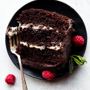 slice of tuxedo cake on a black plate with a fork