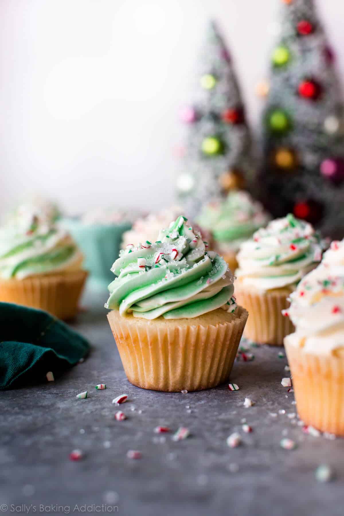 peppermint cupcakes with white and green swirled white chocolate frosting with crushed candy canes and sprinkles