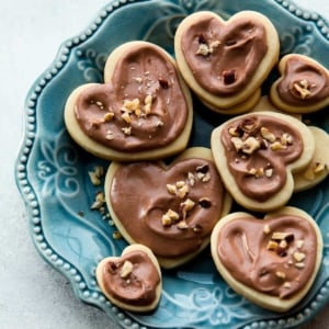 heart sugar cookies with Nutella glaze on a blue plate