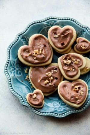 heart sugar cookies with Nutella glaze on a blue plate