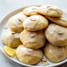 lemon ricotta cookies stacked on a white plate