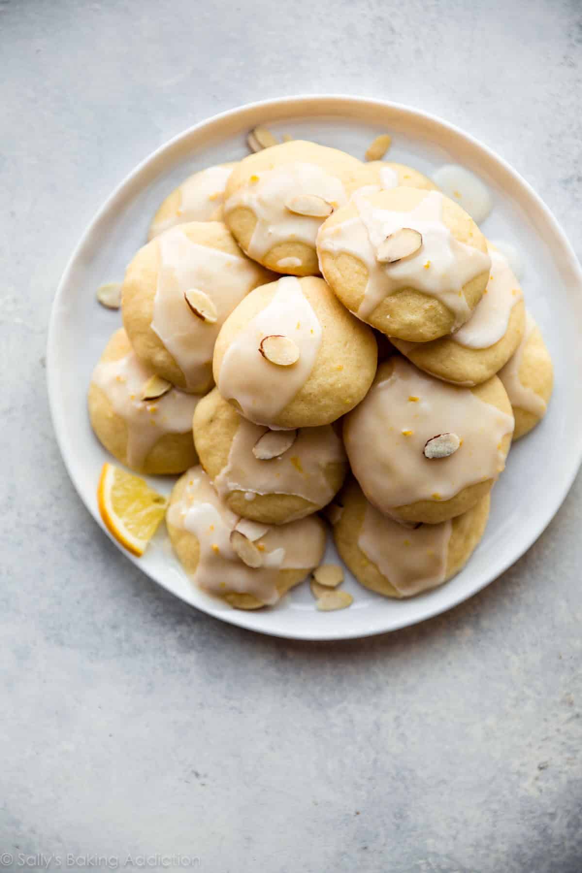 overhead image of lemon ricotta cookies on a white plate