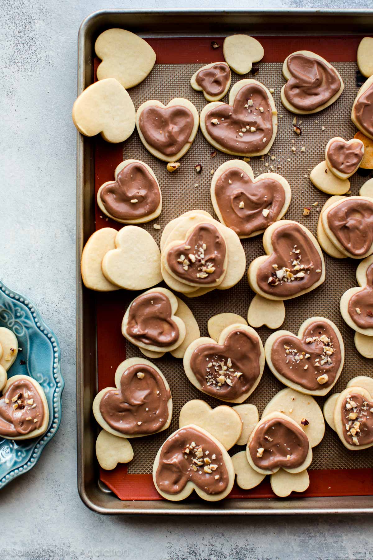 heart sugar cookies with Nutella glaze on a baking sheet