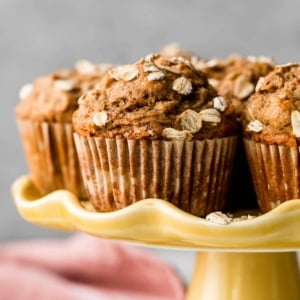 whole wheat healthy banana muffins on yellow cake stand