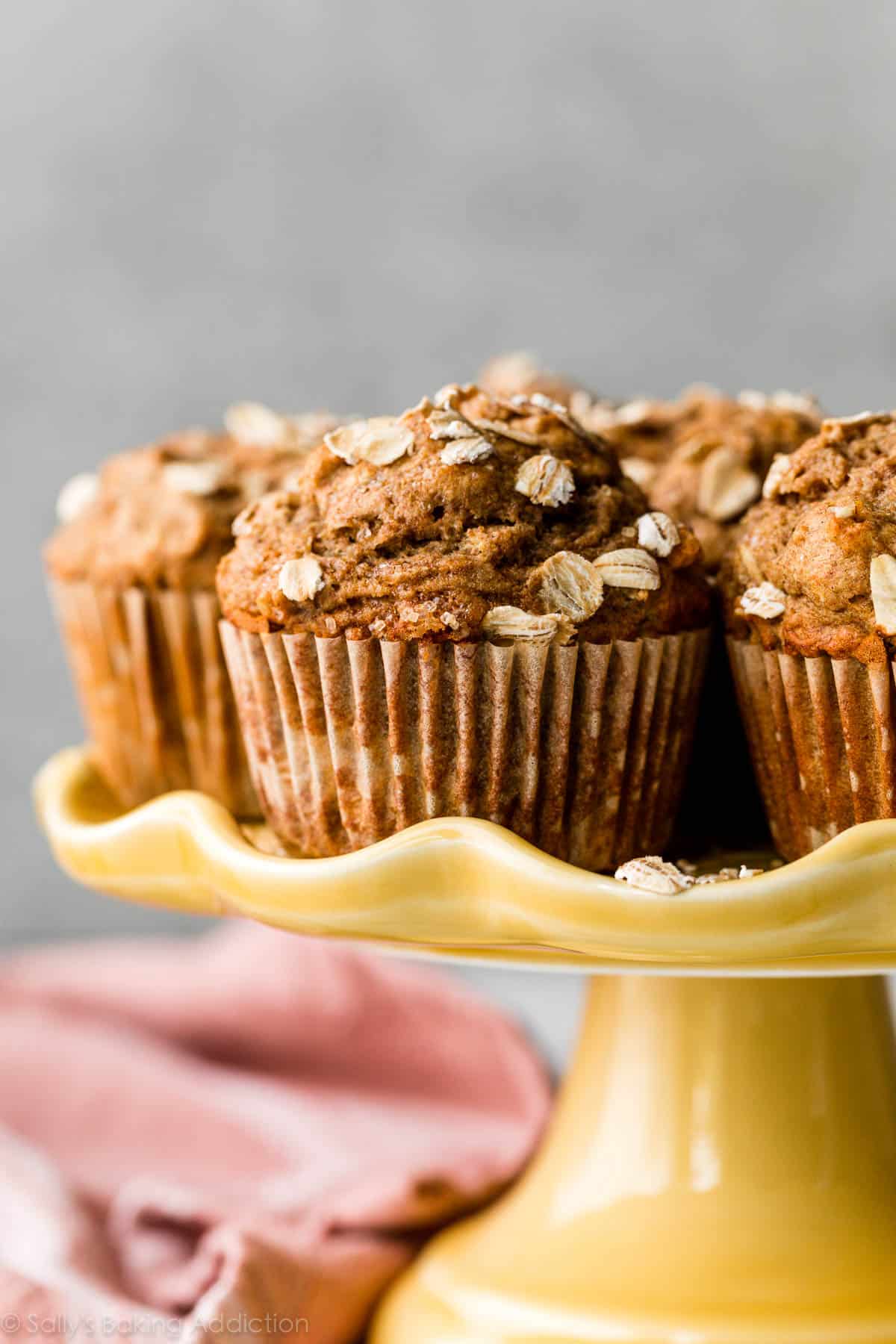 whole wheat healthy banana muffins on yellow cake stand