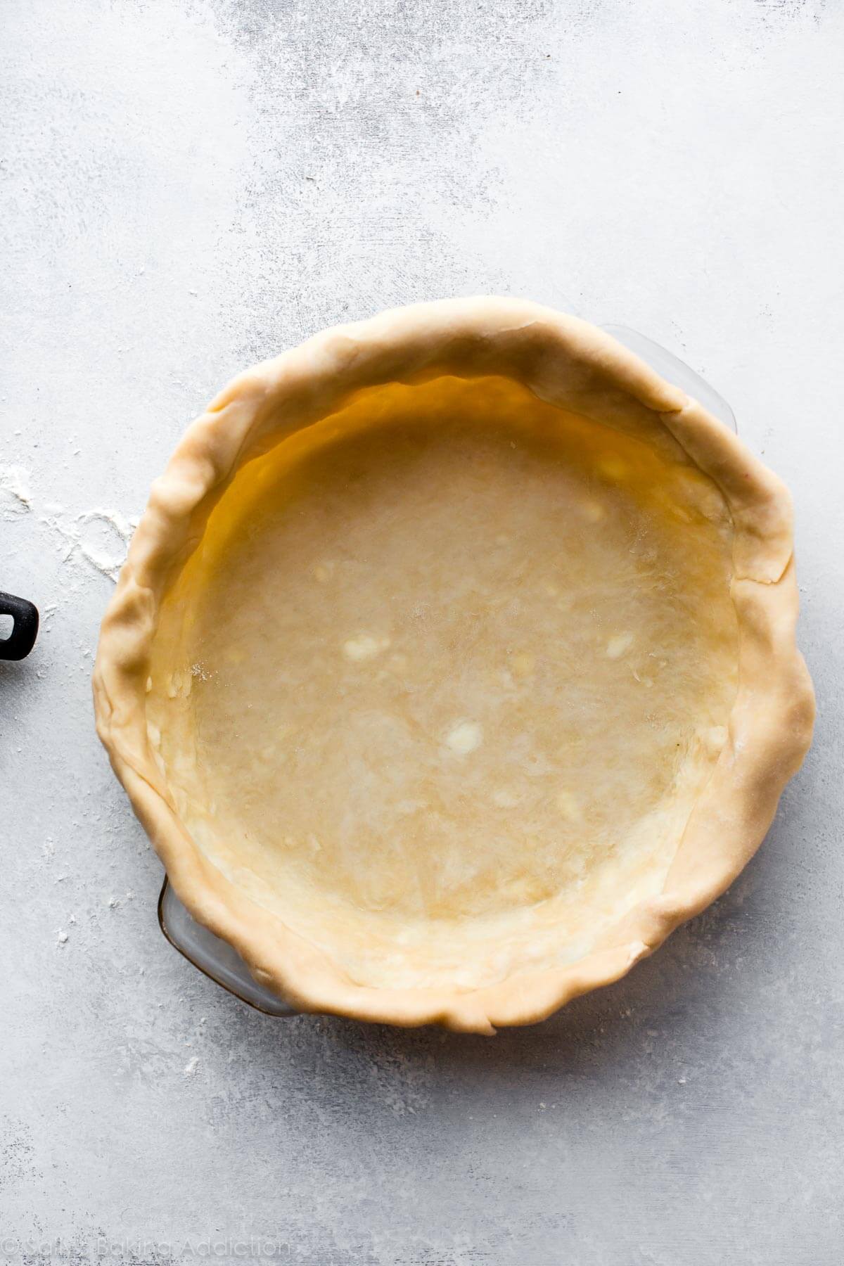 pie dough in a pie dish before baking