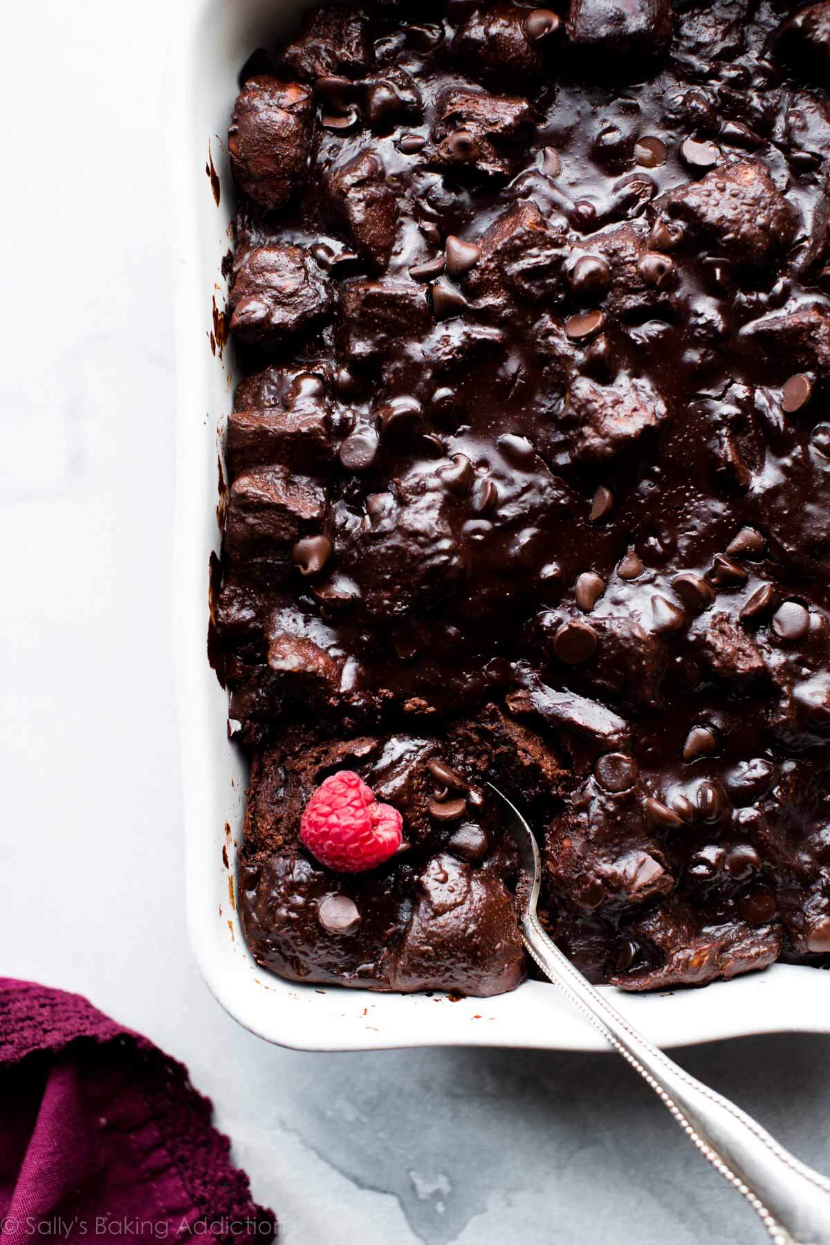 overhead image of dark chocolate bread pudding in a white baking dish