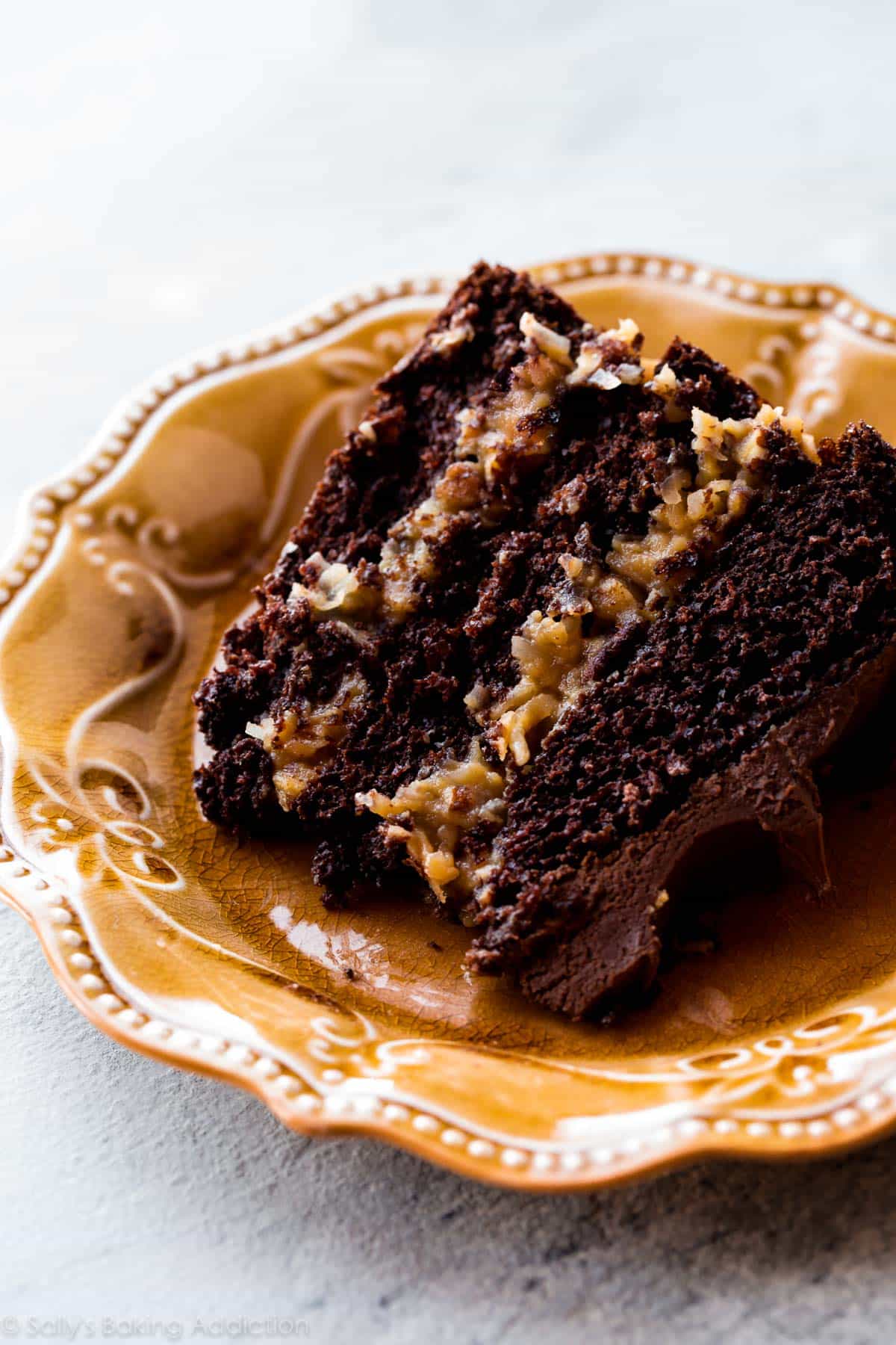 slice of German chocolate cake on a gold plate