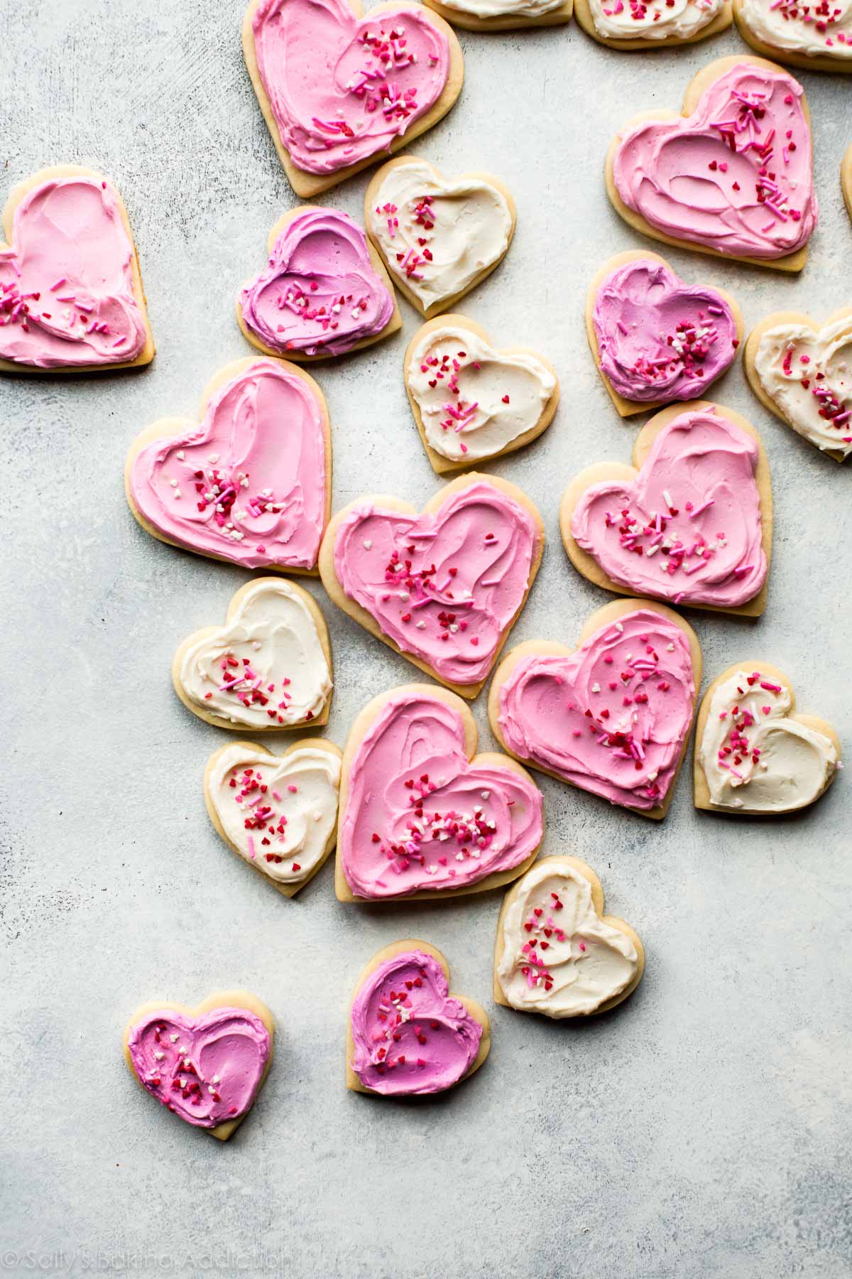 heart sugar cookies with pink frosting and sprinkles