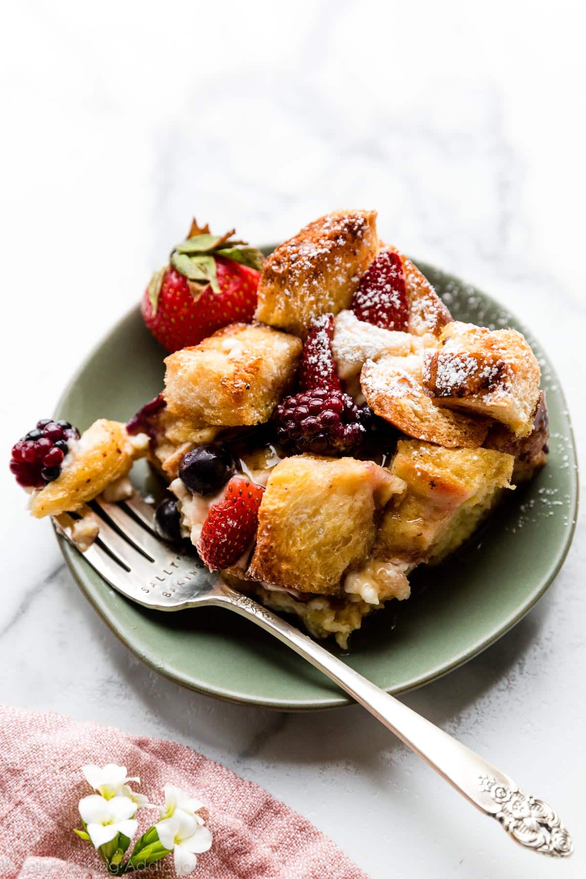serving of mixed berry cream cheese French toast bake on green plate
