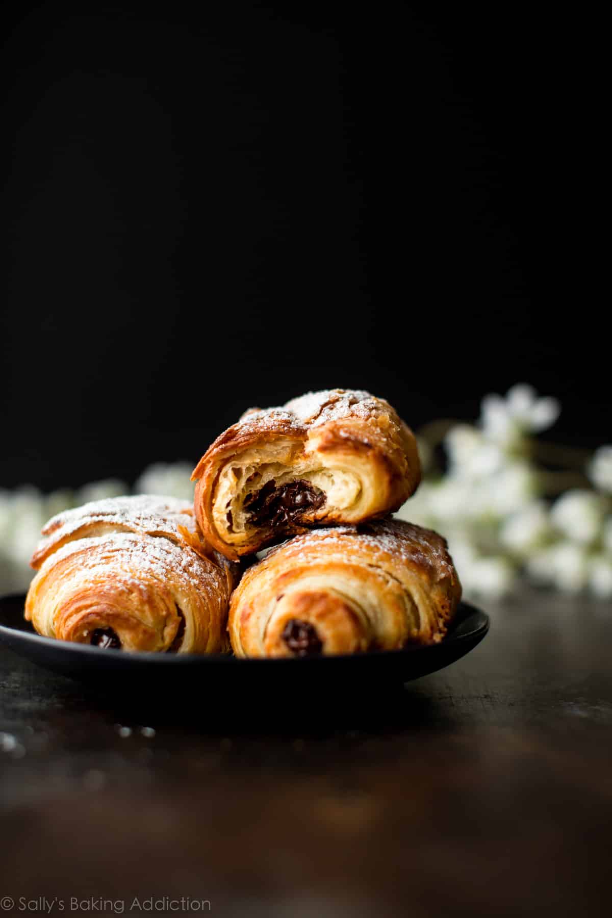 chocolate croissants on a black plate