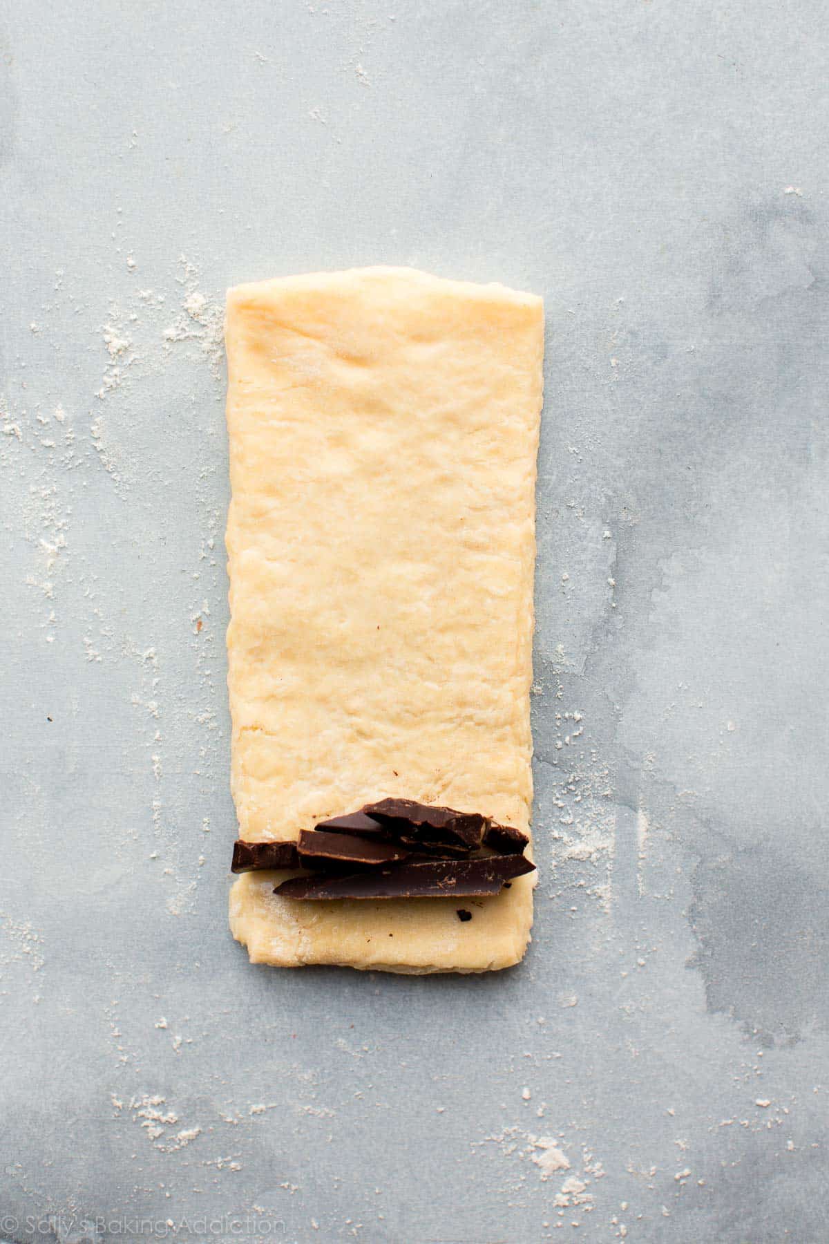 strip of croissant pastry dough with chocolate before rolling