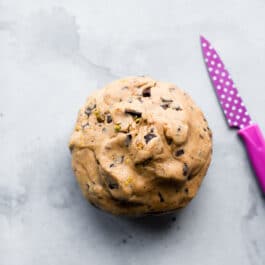 pistachio chocolate chunk cookie dough rolled into a ball