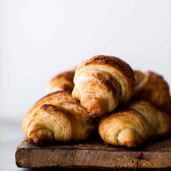 croissants on a wood serving tray