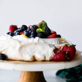 pavlova on a marble and wood cake stand