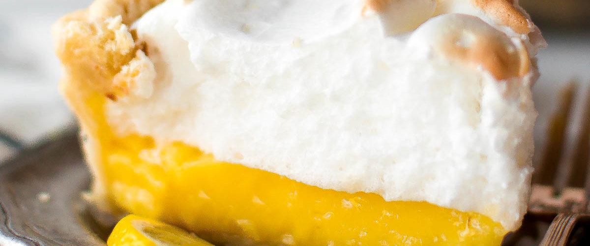 Lemon meringue pie slice on a silver plate