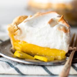 Lemon meringue pie slice on a silver plate