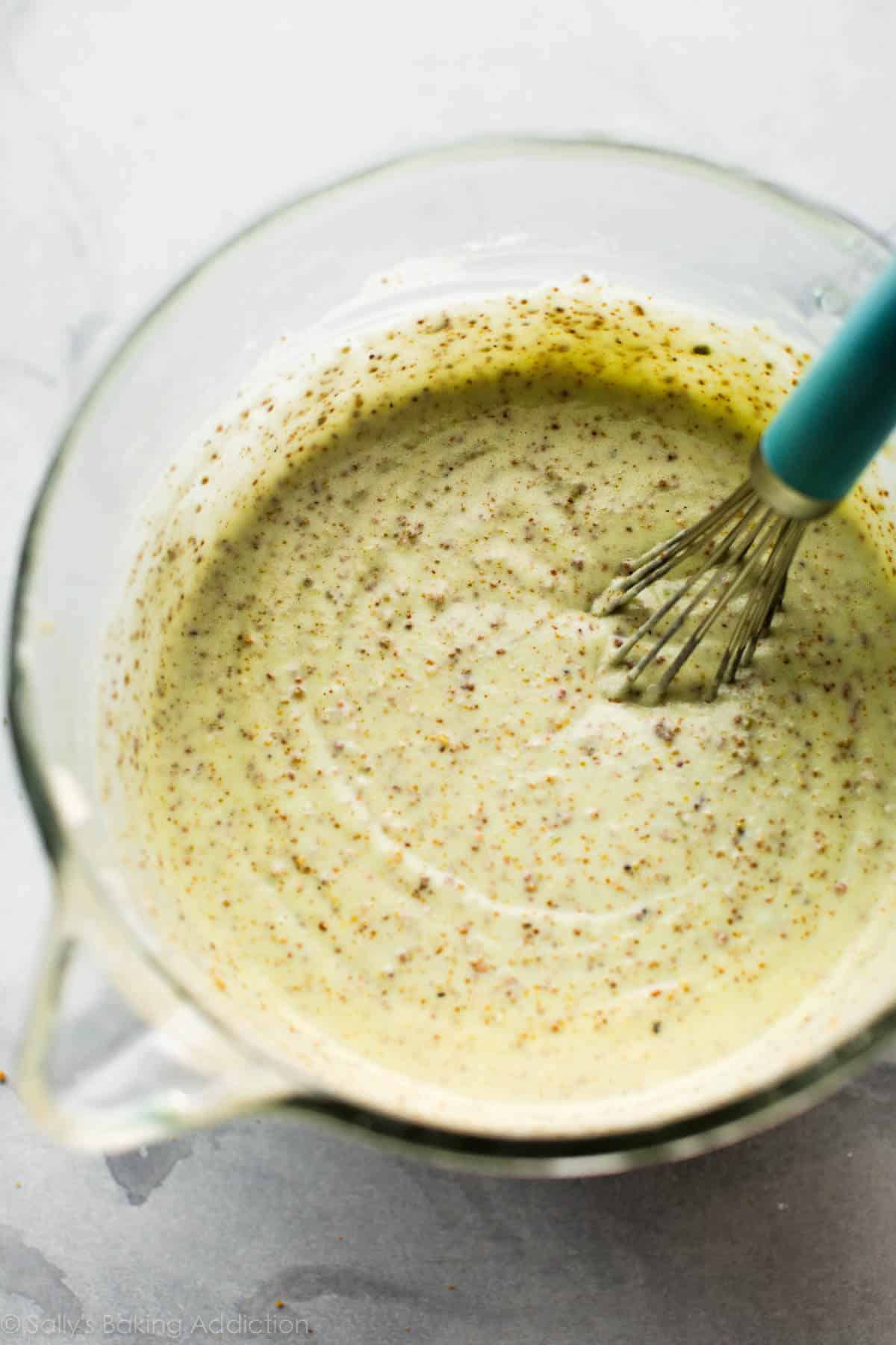 pistachio cake batter in a glass bowl