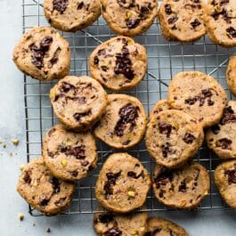pistachio chocolate chunk cookies on a cooling rack