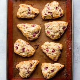 overhead image of strawberry lemon poppy seed scones on a silpat baking mat on a baking sheet