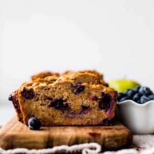 healthy apple blueberry bread on a wood serving tray