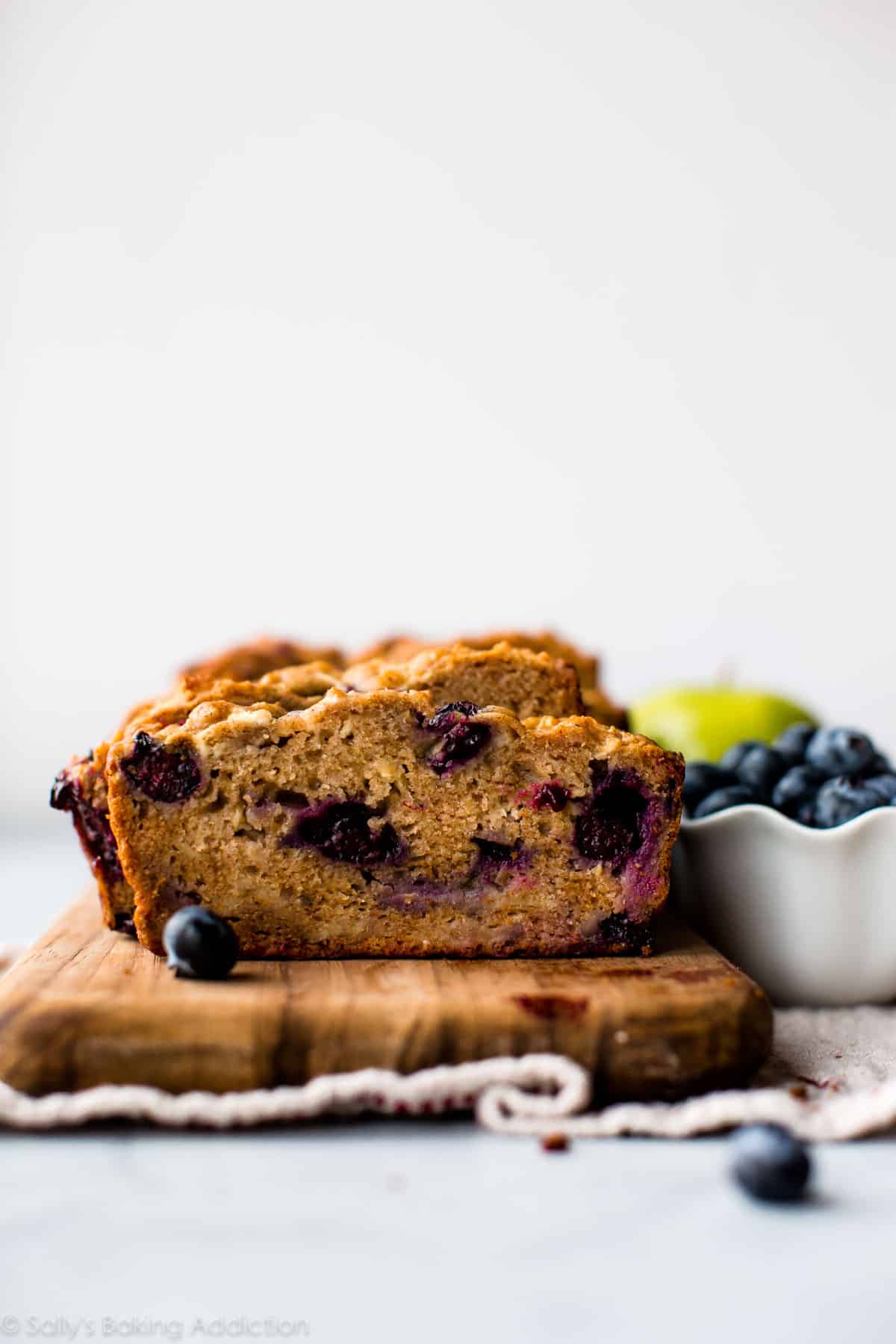healthy apple blueberry bread on a wood serving tray
