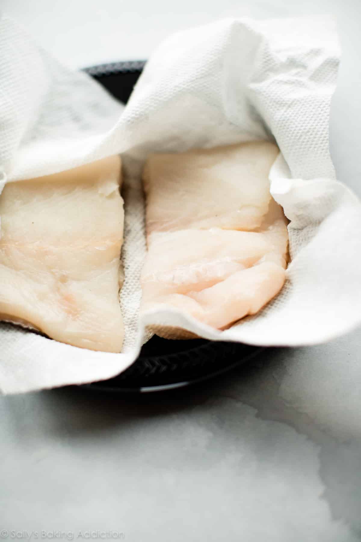 blotting halibut with paper towel
