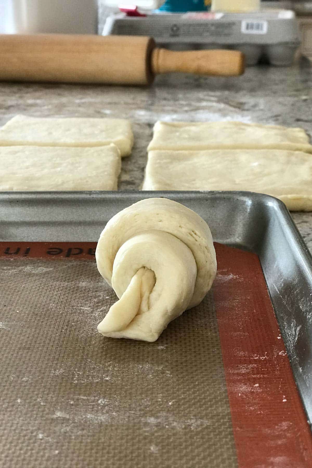 croissant on a baking sheet before baking