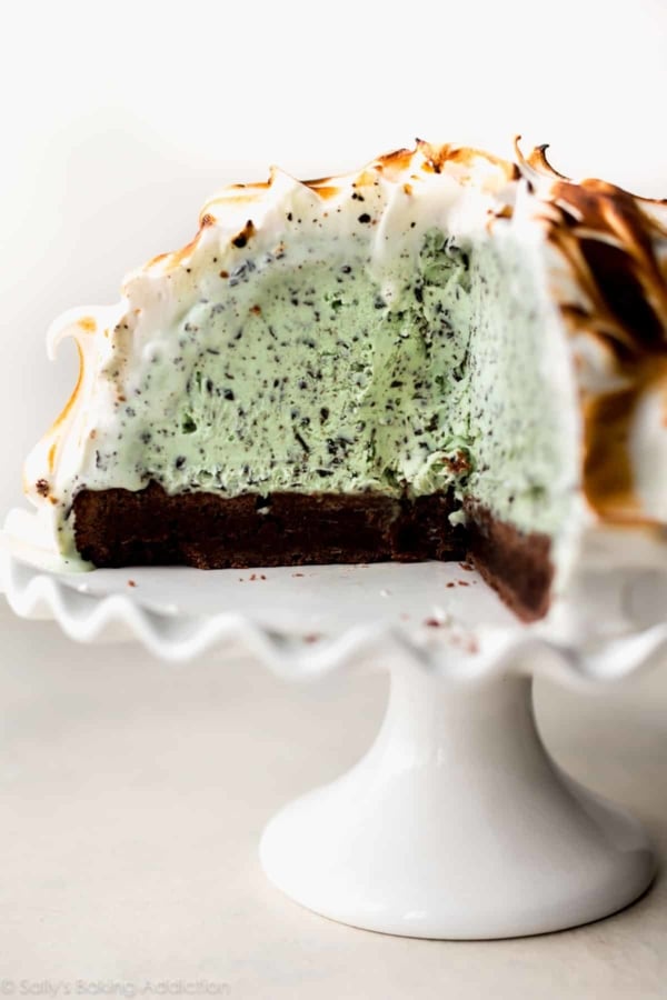 brownie baked Alaska on a white cake stand