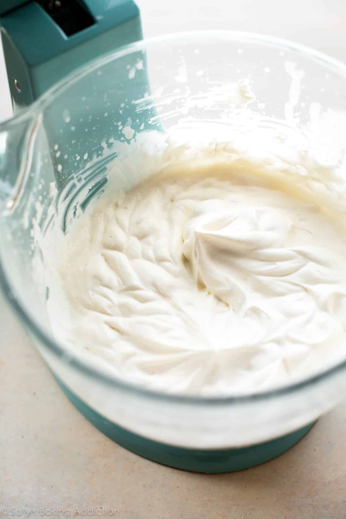 homemade whipped cream in a glass stand mixer bowl