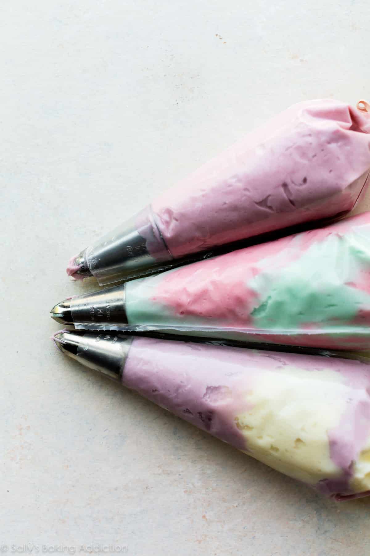 piping bags filled with colorful frosting