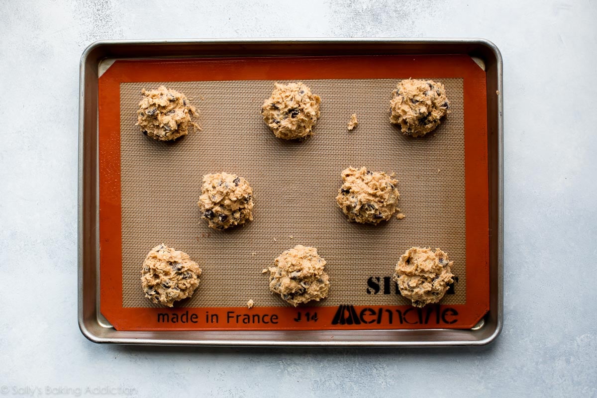 peanut butter oatmeal chocolate chip cookie dough on baking sheet before baking