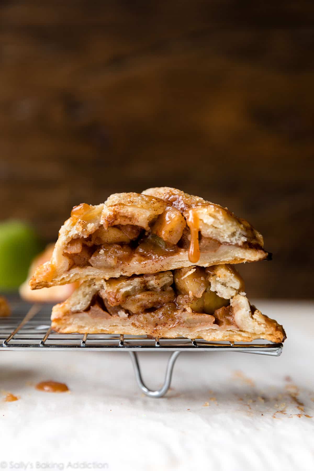 apple hand pie cut in half and stacked on a cooling rack